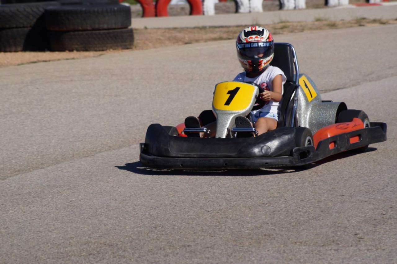 A red go-kart with a driver
